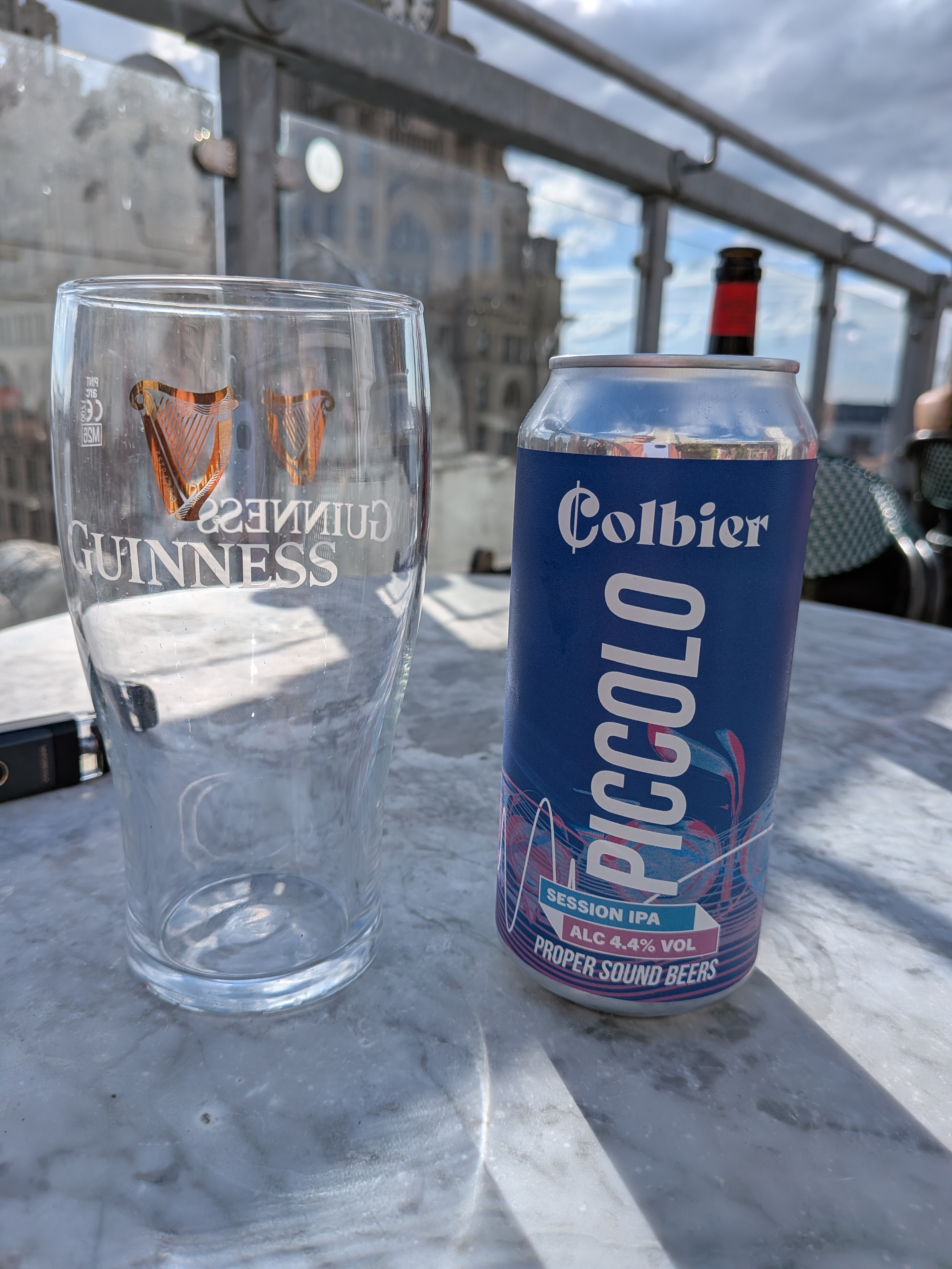 A Guinness glass and a Piccolo session IPA on the rooftop table