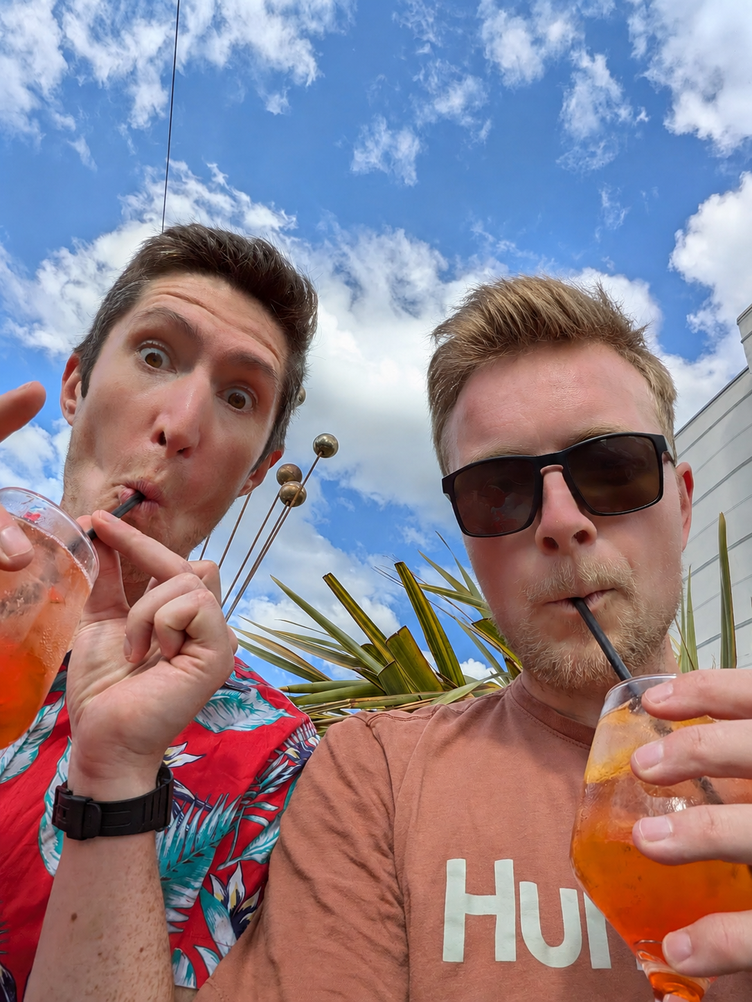 Joe and Richard sipping Aperol Spritz on a rooftop bar